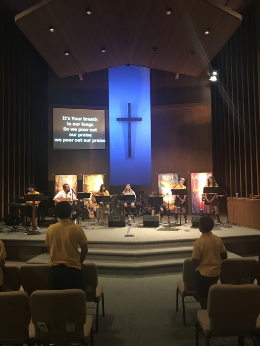 Middle school students entering into worship during chapel. 